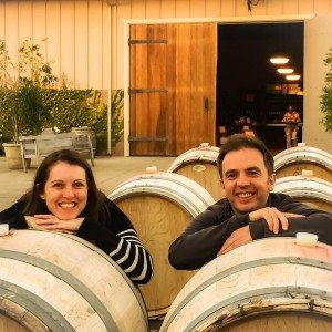 couple by wine barrels