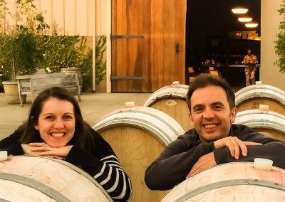 couple by wine barrels